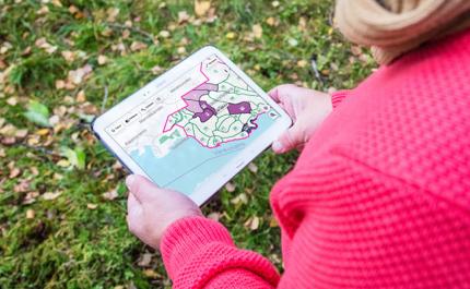 Henkilö tutkii Metsään.fi-palvelua tabletilla.
